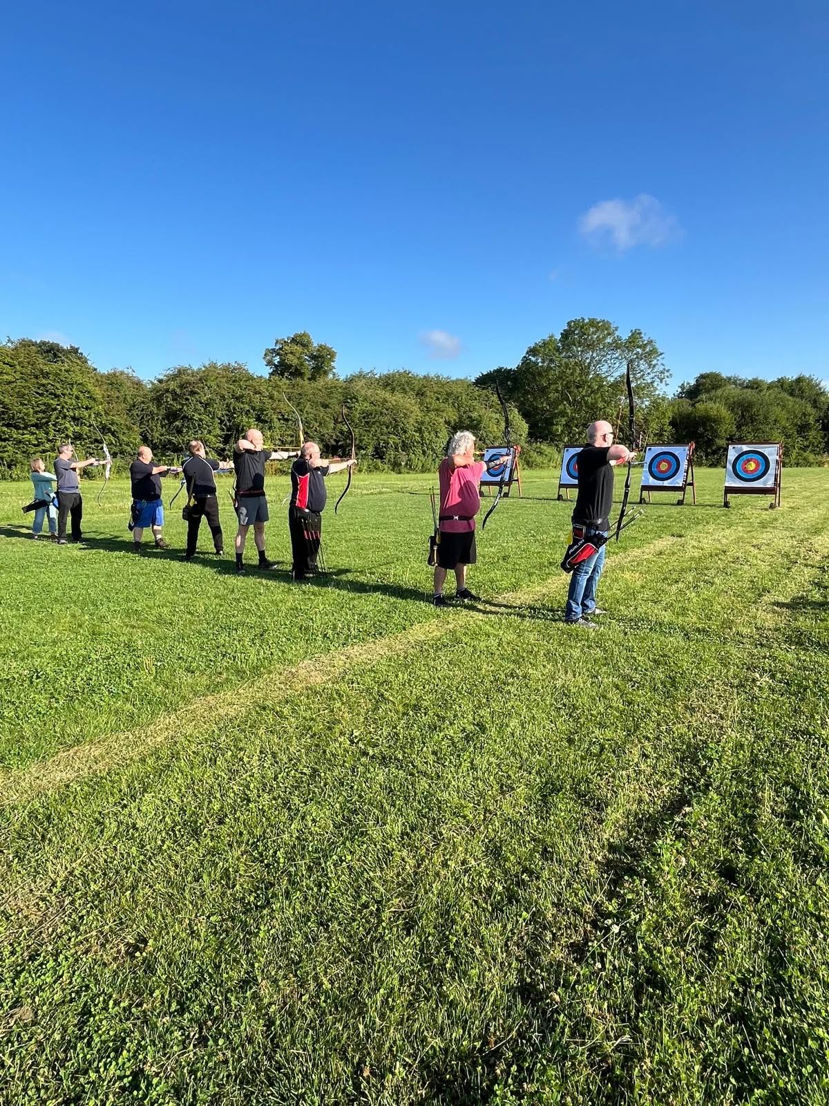 Club members shooting on the field